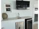 Outdoor kitchen area with a sink, bar fridge and countertop at 7912 Causeway S Blvd, St Petersburg, FL 33707