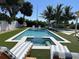Backyard with pristine swimming pool, spa, poolside lounge chairs and lush landscaping at 7912 Causeway S Blvd, St Petersburg, FL 33707