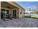Enjoy outdoor living on the paver patio next to the manicured lawn at 8247 Westhaven Dr, Land O Lakes, FL 34638