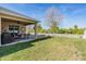 Covered patio perfect for outdoor dining, lush lawn with a playset, and a fenced yard for privacy at 8247 Westhaven Dr, Land O Lakes, FL 34638