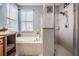 Bright bathroom featuring a tub with tile surround and a glass shower with a handheld shower head at 8247 Westhaven Dr, Land O Lakes, FL 34638