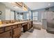 Bathroom featuring a double vanity with granite counters, tub, glass shower, and tile flooring at 8247 Westhaven Dr, Land O Lakes, FL 34638