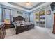 Bright bedroom with large windows and patio access, featuring a dark wood sleigh bed and neutral carpet at 8247 Westhaven Dr, Land O Lakes, FL 34638