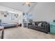 Bright bedroom with vaulted ceiling, a bed, seating, vanity, and carpet flooring at 8247 Westhaven Dr, Land O Lakes, FL 34638