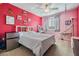 Bright bedroom featuring pink walls, white furniture, ceiling fan, and hanging hammock chair at 8247 Westhaven Dr, Land O Lakes, FL 34638