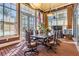 Well-lit conference room with large windows, an American flag, a large meeting table and comfortable leather chairs at 8247 Westhaven Dr, Land O Lakes, FL 34638