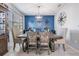 Charming dining area with modern table set, blue accent wall and decorative compass at 8247 Westhaven Dr, Land O Lakes, FL 34638