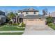 Charming two-story home boasts a manicured lawn, brick driveway, and an attached three-car garage at 8247 Westhaven Dr, Land O Lakes, FL 34638