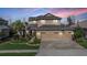 Charming two-story home with a three-car garage, driveway pavers, and mature landscaping at 8247 Westhaven Dr, Land O Lakes, FL 34638