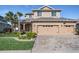 Charming two-story home with a three-car garage and neatly landscaped front yard at 8247 Westhaven Dr, Land O Lakes, FL 34638