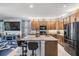 A modern kitchen features granite countertops, wooden cabinets, a large island and stainless steel appliances at 8247 Westhaven Dr, Land O Lakes, FL 34638