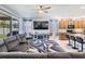 Comfortable living room with a gray sofa, ceiling fan, and stylish rug adjacent to the kitchen at 8247 Westhaven Dr, Land O Lakes, FL 34638
