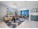 Open living space featuring tiled floors, dining area, sofa and foosball table at 8247 Westhaven Dr, Land O Lakes, FL 34638