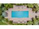 Overhead shot of a rectangular swimming pool surrounded by lounge chairs, tables, and palm trees at 8247 Westhaven Dr, Land O Lakes, FL 34638
