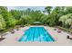 Community pool featuring tables, chairs, landscaping, trees and sunshade cabana at 8247 Westhaven Dr, Land O Lakes, FL 34638