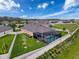 Aerial view of a home featuring a screened pool, lush yard, and a secure fence at 8578 Gibbons Grove Loop, Land O Lakes, FL 34637