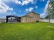 The large backyard with a screened pool is perfect for outdoor activities and relaxation at 8578 Gibbons Grove Loop, Land O Lakes, FL 34637