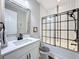 Bathroom boasting tile accents, framed mirror, modern vanity, and shower with dark hardware at 8578 Gibbons Grove Loop, Land O Lakes, FL 34637
