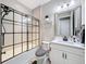 Modern bathroom with tiled shower, glass door, updated vanity, and decorative shelving at 8578 Gibbons Grove Loop, Land O Lakes, FL 34637