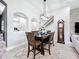 Elegant dining room with stylish furnishings, modern lighting, and easy access to the staircase at 8578 Gibbons Grove Loop, Land O Lakes, FL 34637