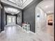 Elegant foyer with archways, a chandelier, decorative clocks, and a view to other rooms at 8578 Gibbons Grove Loop, Land O Lakes, FL 34637