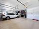 Well-organized garage with epoxy flooring, storage, and ample space for parking at 8578 Gibbons Grove Loop, Land O Lakes, FL 34637