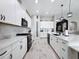 Well-equipped kitchen with stainless steel appliances, white cabinets, and an open layout for easy entertaining at 8578 Gibbons Grove Loop, Land O Lakes, FL 34637