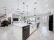 Bright, open kitchen features a large island with pendant lighting and seamlessly flows into the living area at 8578 Gibbons Grove Loop, Land O Lakes, FL 34637
