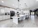 Expansive kitchen with a large island, white cabinets, modern appliances, and seating for casual dining at 8578 Gibbons Grove Loop, Land O Lakes, FL 34637