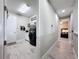 Convenient laundry room adjacent to hallway with modern washer/dryer and storage solutions at 8578 Gibbons Grove Loop, Land O Lakes, FL 34637