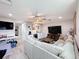 Comfortable living room with a ceiling fan, wet bar, and large screen television for entertaining at 8578 Gibbons Grove Loop, Land O Lakes, FL 34637