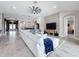 Comfortable living room featuring a stone accent wall, plush seating, and an open layout at 8578 Gibbons Grove Loop, Land O Lakes, FL 34637