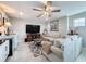 Cozy living room features a ceiling fan, wet bar, large sectional couch and a large screen television at 8578 Gibbons Grove Loop, Land O Lakes, FL 34637