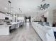 Open-concept living space with kitchen, dining, and living room featuring modern finishes and plenty of natural light at 8578 Gibbons Grove Loop, Land O Lakes, FL 34637