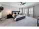 Spacious main bedroom featuring tray ceilings, recessed lights, plantation shutters, and neutral tones at 8578 Gibbons Grove Loop, Land O Lakes, FL 34637