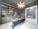 Stylish home office with custom built-in shelving, a modern desk, and bright lighting at 8578 Gibbons Grove Loop, Land O Lakes, FL 34637