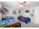 Bedroom featuring ceiling fan, window and twin beds for children at 8766 91St St, Seminole, FL 33777