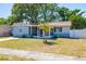 Charming single-story home with a well-maintained lawn, palm tree, and screened front porch at 8766 91St St, Seminole, FL 33777