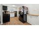 Updated kitchen with black appliances, butcher block countertops, and white cabinets at 8766 91St St, Seminole, FL 33777