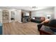 Open living room features wood flooring, a modern ceiling fan, and a custom accent wall at 8766 91St St, Seminole, FL 33777