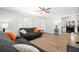 Bright living room featuring wood-look flooring, a modern ceiling fan, and neutral paint at 8766 91St St, Seminole, FL 33777