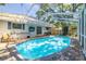 Private screened pool area with brick patio, lounge chairs, and surrounding residential architecture at 8766 91St St, Seminole, FL 33777