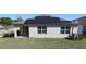 Aerial view of home with solar panels, green lawn, and an outdoor living space at 901 Golden Shiner Ave, Ruskin, FL 33570