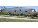 Exterior view of the backyard showcasing a well-maintained lawn and simple landscaping at 901 Golden Shiner Ave, Ruskin, FL 33570