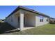 An exterior view of the covered patio, offering a private outdoor living space at 901 Golden Shiner Ave, Ruskin, FL 33570
