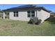 The house features solar panels, a well-maintained lawn, and an energy-efficient AC unit at 901 Golden Shiner Ave, Ruskin, FL 33570