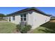 The home's exterior is complemented by green lawns and functional air conditioning unit at 901 Golden Shiner Ave, Ruskin, FL 33570