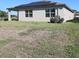 View of the home exterior, featuring solar panels and a sprawling green lawn at 901 Golden Shiner Ave, Ruskin, FL 33570