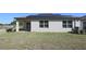 Exterior of the home with solar panels, neat landscaping, and lush green lawn at 901 Golden Shiner Ave, Ruskin, FL 33570