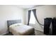 This bedroom features neutral walls, carpet flooring, and a cushioned headboard for comfortable sleeping at 901 Golden Shiner Ave, Ruskin, FL 33570